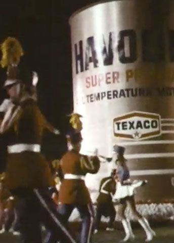 Texaco display on a marching bandMarching band on a field with the Texaco logo on the back.